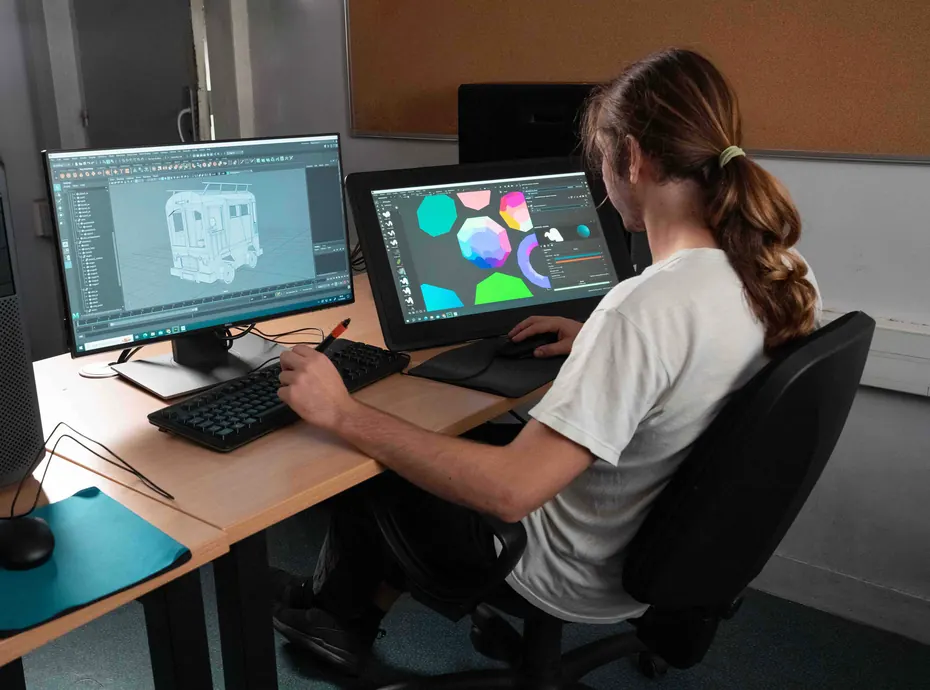 Matte painter: an ESRA student painting on a graphics tablet in front of his screens
